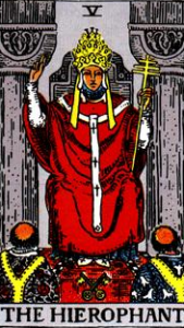 The Hierophant, sitting between those same two pillars and speaking to two different/opposing clergymen. This card actually shows two triads.